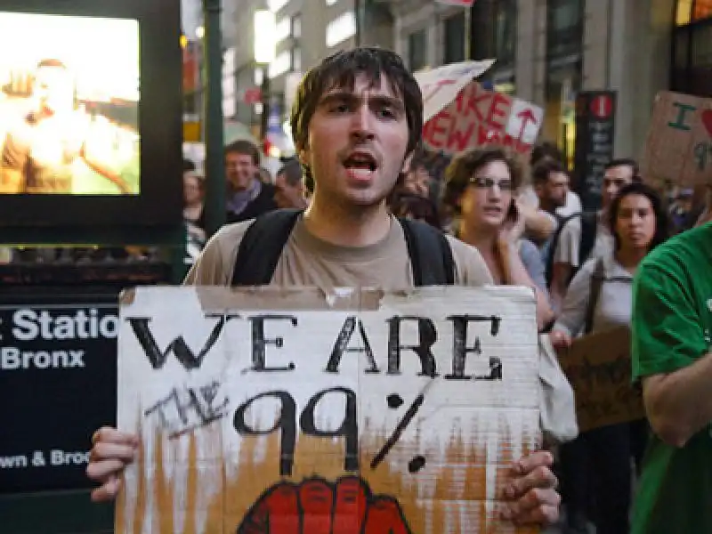 man with sign marching for occupy wall street in nyc 