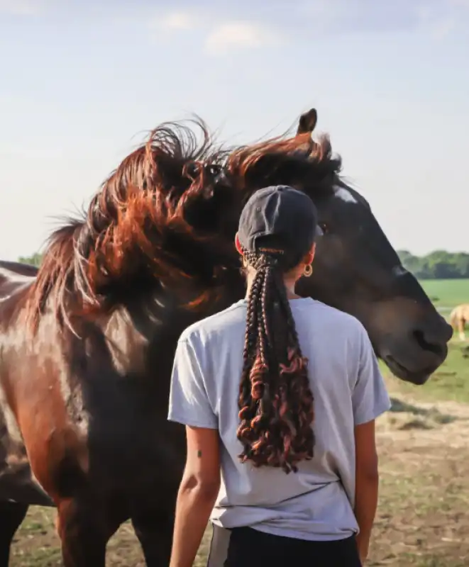 ragazza con i capelli afro a cavallo