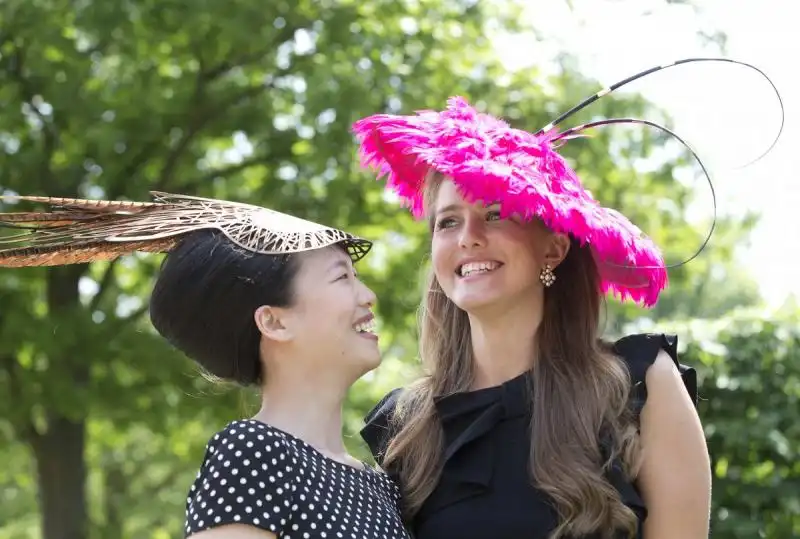 friends veronica voronina right and rosey chan laughed as they posed for the media in their hats 