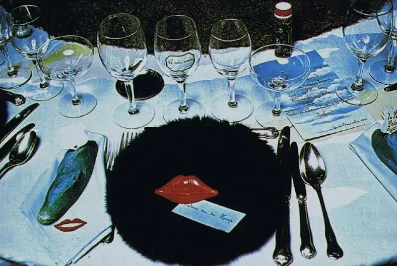 Detail of a table with a fur dish Mae West red lips and a blue bread 