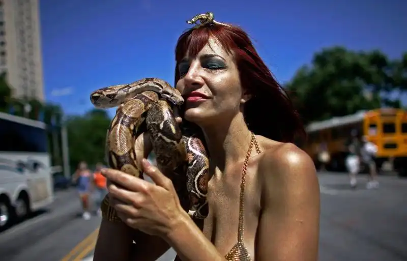 MERMAID HISTORY a bronzed mermaid holds her snake at the march the parade is entirely animal friendly and hundreds of pets march each year in full costume 