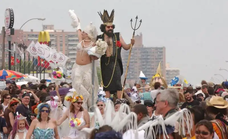 MERMAID HISTORY king neptune and his mermaid queen make their way down the street at the parade 