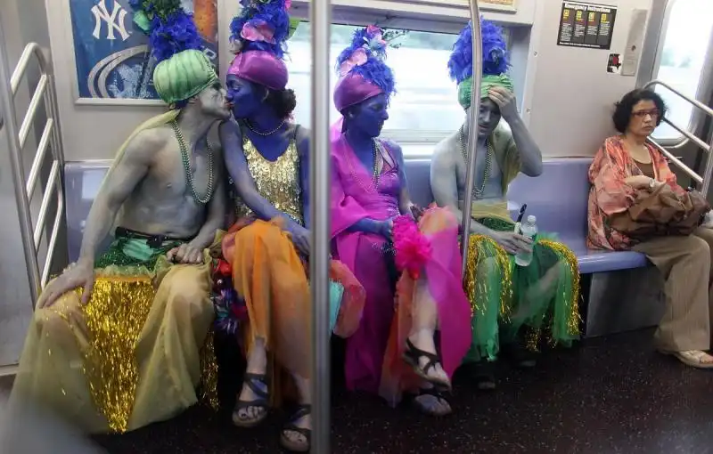 MERMAID HISTORY two mermaids kiss on the subway after the mermaid parade comes to an end 