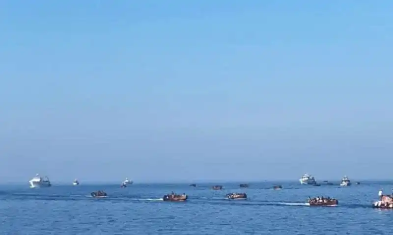  fila di barchini carichi di migranti al molo di lampedusa2