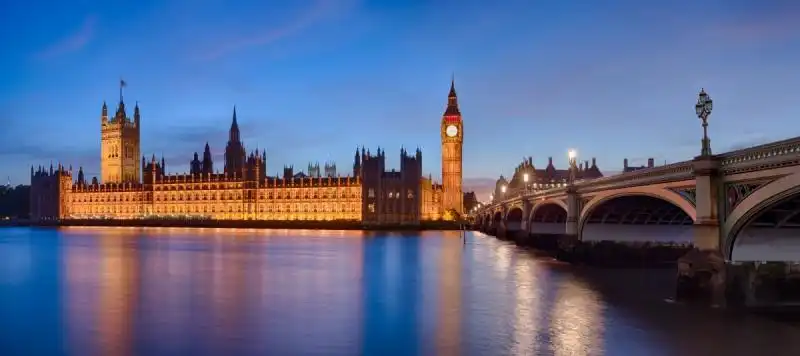 a panoramic view of the london parliament big ben and the westminster bridge 