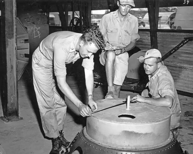 soldiers check the casings on the fat man atomic bomb multiple test bombs were created on tinian island all were roughly identical to an operational bomb even though they lacked the necessary equipmen