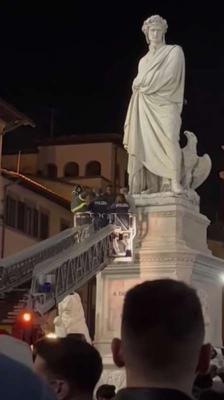 senegalese si arrampica su statua dante a firenze 5