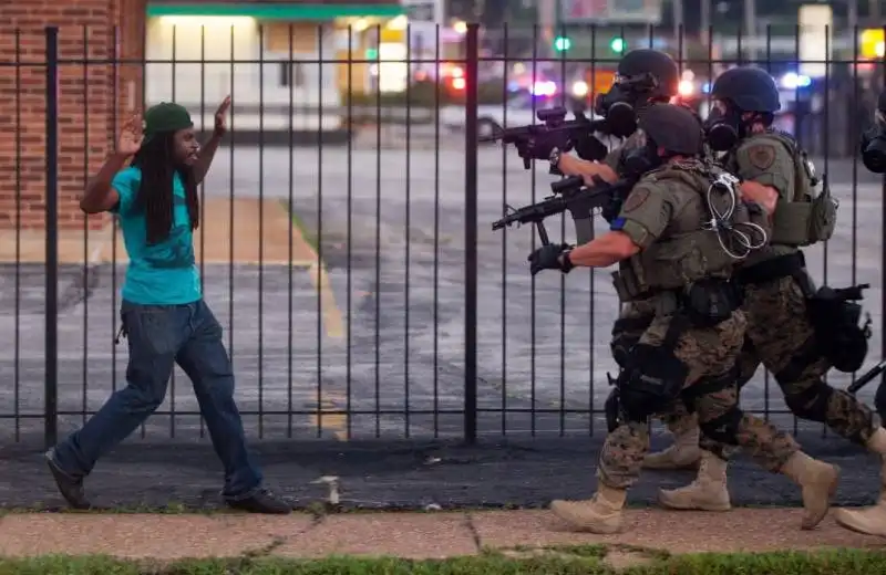 a man backed away from law enforcement officers at a demonstration