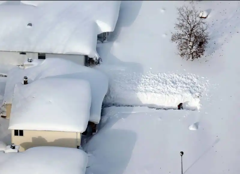 a man cleared his driveway after more than five feet of snow hit parts of the buffalo area